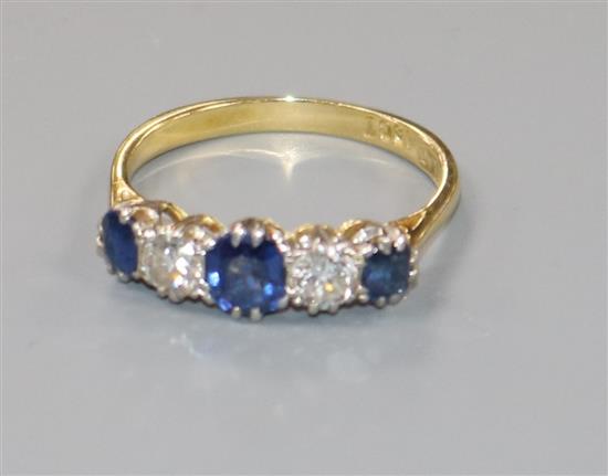 An 18ct gold and platinum, sapphire and diamond five stone ring, size M/N.